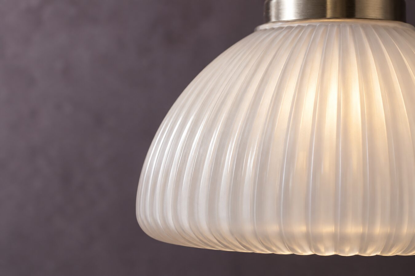 Close view of softly illuminated ribbed opal glass